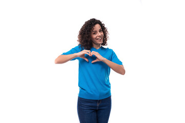 young bright smiling woman with curls dressed in a blue t-shirt with mockup