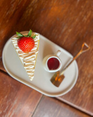 Strawberry vanilla cake eaten with strawberry sauce.