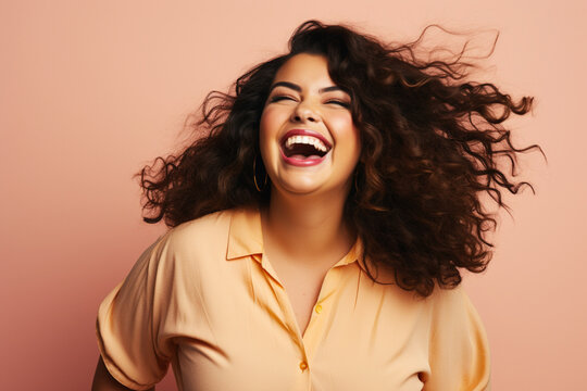 Attractive obese hispanic woman looking excited while laughing and having fun