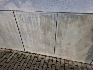 cladding of the house consists of concrete slabs with gaps with a ventilation grid protecting the...