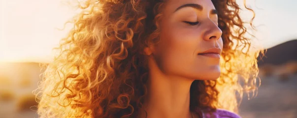 Fotobehang Close up sunset portrait of attractive woman with closed eyes and sun in back light, Dreaming and enjoying feeling concept lifestyle emotion, Serene female people outdoor with curly hair © alisaaa