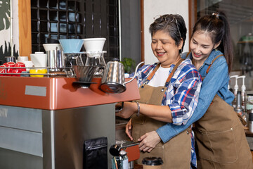 A heartwarming moment between two baristas in a coffee shop. The younger barista playfully hugs her...