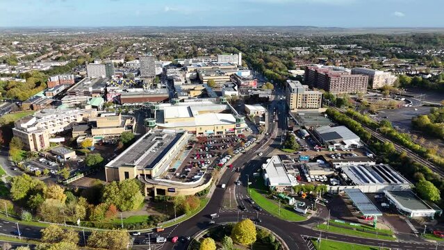 Reverse aerial view of full parking and traffic near a roundabout in Basildon