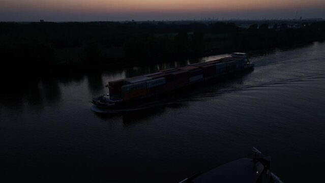 Darkened Waters: Cargo Boat Nightfall Voyage. Silhouette of 'Cugini' Cargo Ship at Dusk