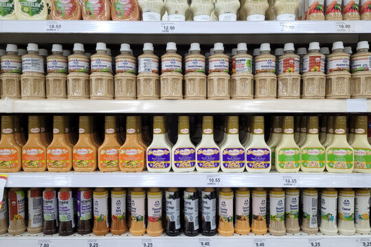 PENANG, MALAYSIA - 11 SEP 2023: Various brands of mayonnaise, salad spread, and BBQ sauce are tastefully displayed on the store shelves at Giant Grocer.
