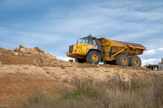 Large dump truck. Big yellow truck at work site.