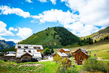 Wooden chalets nestled in idyllic mountain landscape. © FotoToc