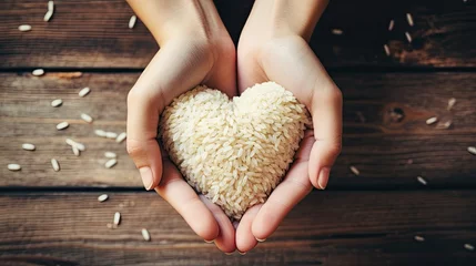Poster de jardin Pain Hands holding rice with a heart shape. 