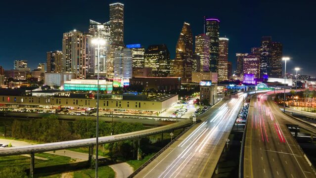 Aerial Hyperlapse Drone Fly Above Highway of Houston Texas USA at Night Lighting. Establishing Drone shot of City of Houston at night