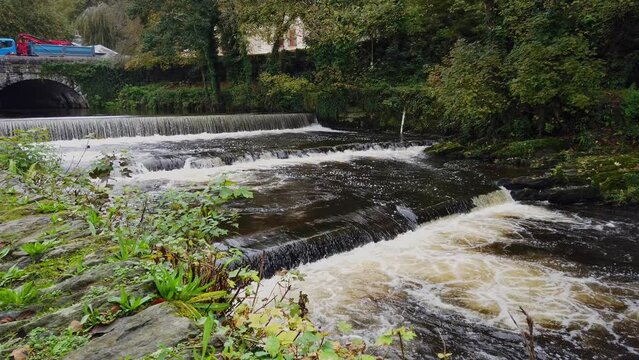 The river Tavy rushing over a weir after passing through the Devon Market town of Tavistock in the United Kingdom
