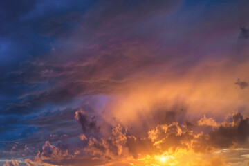 Glowing real sky at sunset texture background overlay. Dramatic red and orange clouds.
