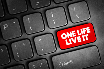 One Life Live It text button on keyboard, concept background