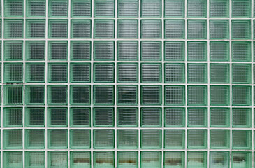 Close up Pattern of green glass block wall seamless background and texture at Thailand.