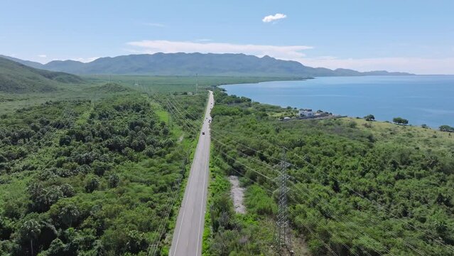 Aerial birds eye shot of CARRETERA SANCHEZ road in exotic landscape during sunny day, Dominican Republic 