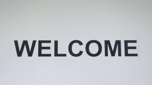 The text WELCOME typed on a word processing application changing the color of text from black to red.