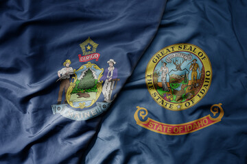 big waving colorful national flag of idaho state and flag of maine state .
