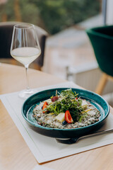 Beef carpaccio with pesto sauce and parmigiano cheese decorated by salad and fruit. Restaurant menu