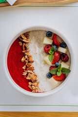 Sweet milk semolina porridge with strawberries on beautiful plate. Delicious breakfast for children