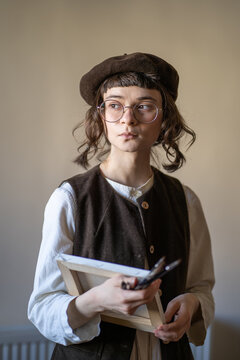Creative illustrator holding canvas, paint brushes. Young artist preparing for work, drawing, sketching. Profession, occupation of tutor, illustrator, painter. Hobby of creating artworks. pictures 