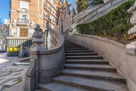 Madrid, Spain - February 21, 2018:  Fuente de Cristino Martos, de los afligidos or de la escalinata. Ornamental fountain and staircase made by Federico Coullant Valera in the Calle Princesa Street.