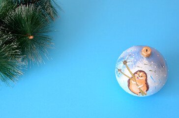 blue christmas sphere and pine branches on blue background copy space   