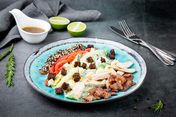 different types of meat, sesame seeds, greens and croutons, side view