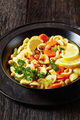 orecchiette pasta chickpea soup in black bowl