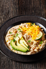 white chicken chili with cheese, avocado in bowl
