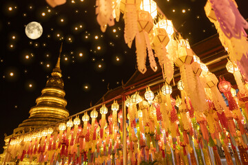 Lantern Festival in Lamphun people hang colorful light lanterns at Wat Phra That Hariphunchai Temple full moon - obrazy, fototapety, plakaty