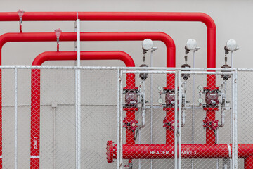 Sprinkler alarm high pressure water supply pipe line with control gauge valve in safety fence area industry building - obrazy, fototapety, plakaty