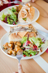 People having a casual food meet up having sanwiches and fast food over lunch.