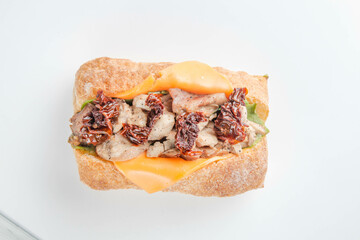 Open faced pesto chicken ciabatta sandwich.