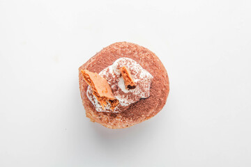 Tiramisu fancy brioche doughnut with topping of honey biscuits and whipped cream.