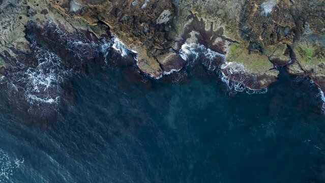 Drone top down video of waves hitting cliffs at Cabo Cervera, Torrevieja, Spain