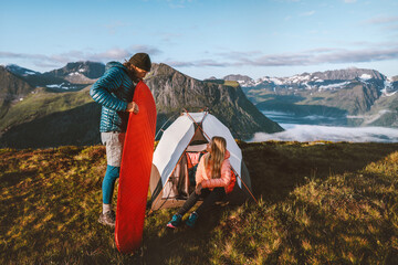 Couple friends setting up tent camping gear travel in mountains, man inflating sleeping pad, active vacations outdoor adventures man and woman hiking together family tour healthy lifestyle in Norway - Powered by Adobe