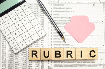 rubric words on wooden blocks with sticker, calculator and pen