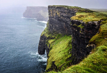 Cliffs of Moher in Ireland during the autumn rainy season - 676304971
