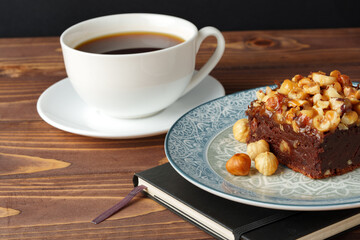 Brownie cake with chocolate and hazelnuts on plate