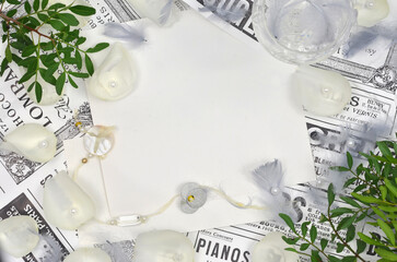 Empty sheet of paper ready to use decorated with leaves, jewelry, feathers, white and black retro newspaper, flat lay. 
