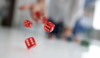 Woman hand throws red dice into air. Good luck gambling bet risk luck win concept