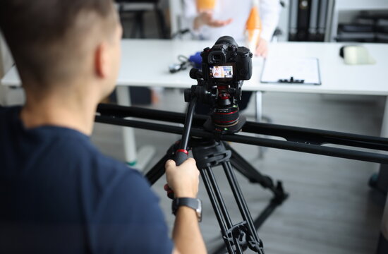 Videographer is filming doctor in clinic. Medical blog and job operator concept
