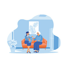 The doctor practitioner is sitting with the adult female patient on the sofa. Doctor showing results of medical examination of an adult female patient. Elderly patient concept.