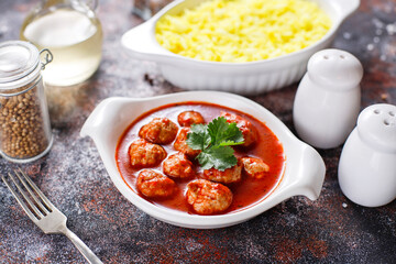 Chicken meatballs with tomato sauce.