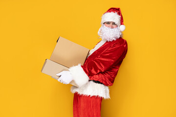 Santa Claus, with boxes, on a yellow background.