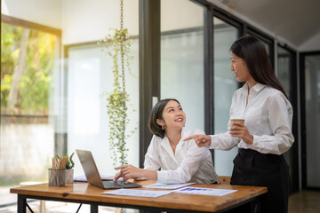 Two business colleagues talking share ideas and express their opinions while working together.