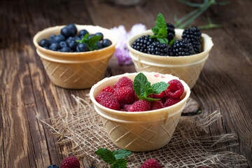 Blackberries, raspberries and blueberries in a waffle bowls.