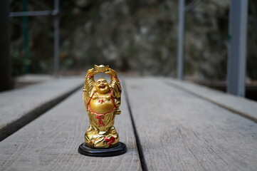 The figure of a smiling Buddha on the background of the bridge.