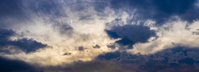 Fototapeta na wymiar Dark ominous sky with blue clouds during sunrise