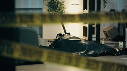 A dead body is lying on the floor in a plastic bag, with evidence markers in a messy room,...