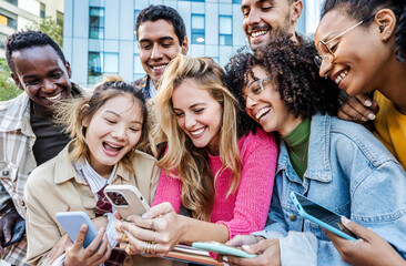 Group of young people using smart mobile phone outdoors - Happy friends with smartphone laughing together watching funny video on social media platform - Tech and modern life style concept - obrazy, fototapety, plakaty
